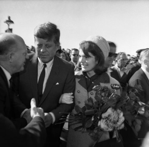 11680065 - President John F. Kennedy and first lady Jacqueline Kennedy on their arrival at the Dallas Airport (Love Field) on Nov. 22, 1963. They are greeting unidentified people. (AP Photo/HWB)