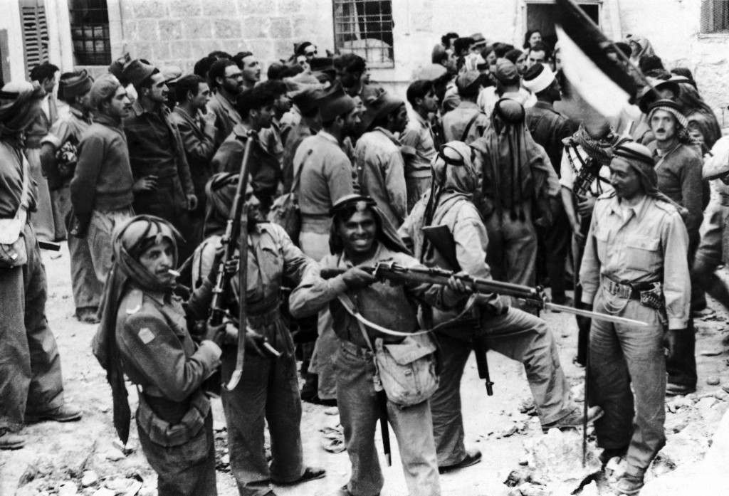 Soldiers of the Transjordan Arab Legion surround Haganah Jewish soldiers and pose with their rifles following their surrender in the old city of Jerusalem, Palestine, May 28, 1948. (AP Photo) Ref #: PA.10005836  Date: 09/06/1948
