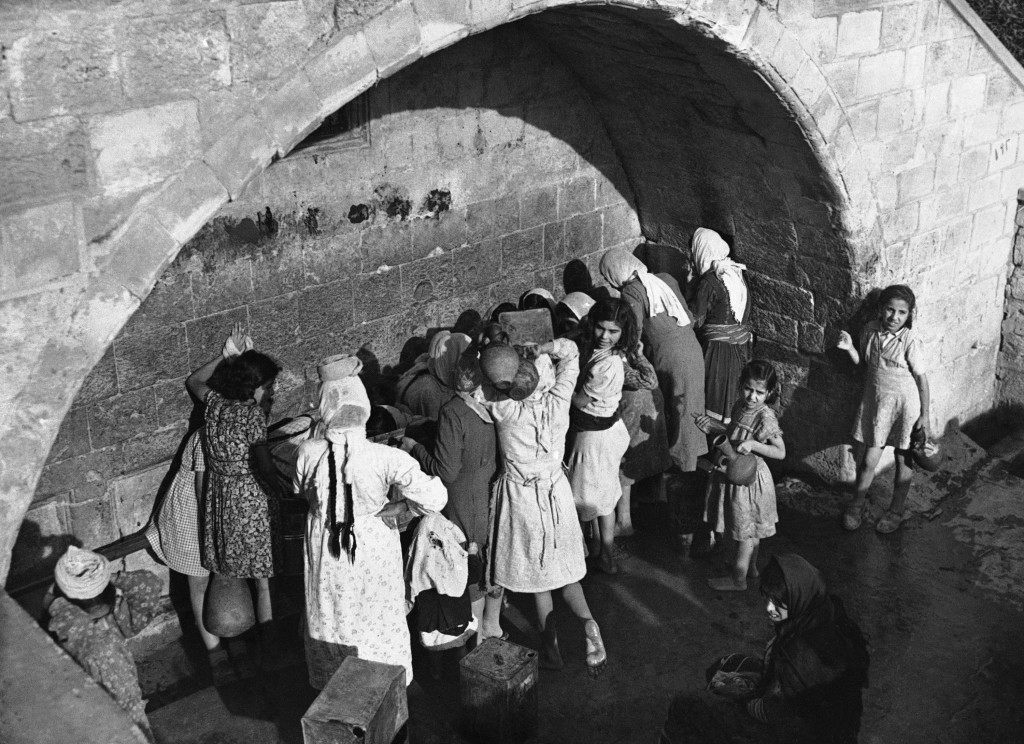 Arab women and children draw water from MaryÂ’s well in Nazareth, Israel, on Dec. 7, 1946, the ancient spring which legend relates supplies water for Mary, Joseph and Jesus. (AP Photo/J. Walter Green) Ref #: PA.10207415  Date: 07/12/1946