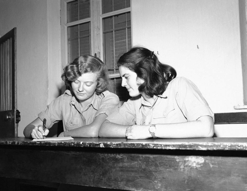 Two Jewish girls fill out their registration forms for the Jewish Army in Israel on Dec. 16, 1947. Many are now members of the semi-official Haganah. (AP Photo) Ref #: PA.10392246  Date: 16/12/1947 