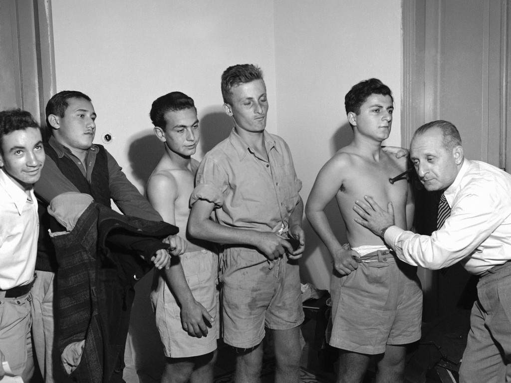 A Jewish doctor examines young Jews in Tel Aviv registration centre in Israel on Dec. 16, 1947 when all were called up for Â“essential dutiesÂ” principally military. (AP Photo/Pringle) Ref #: PA.10392262  Date: 16/12/1947