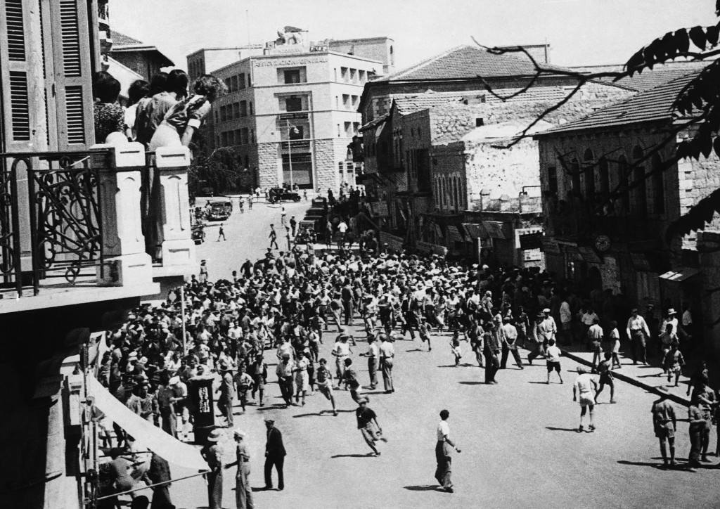 Great civil disturbances, eventually quelled by police and troops, ended a Jewish demonstration against the British proposals for the future of Palestine. One policeman was killed. Jews rushing for cover from before the baton charge of the police during the quelling of the disturbances in Jerusalem, Israel, on May 18, 1939. Note the spectators from the balcony on the left. (AP Photo) Ref #: PA.10878635  Date: 18/05/1939 