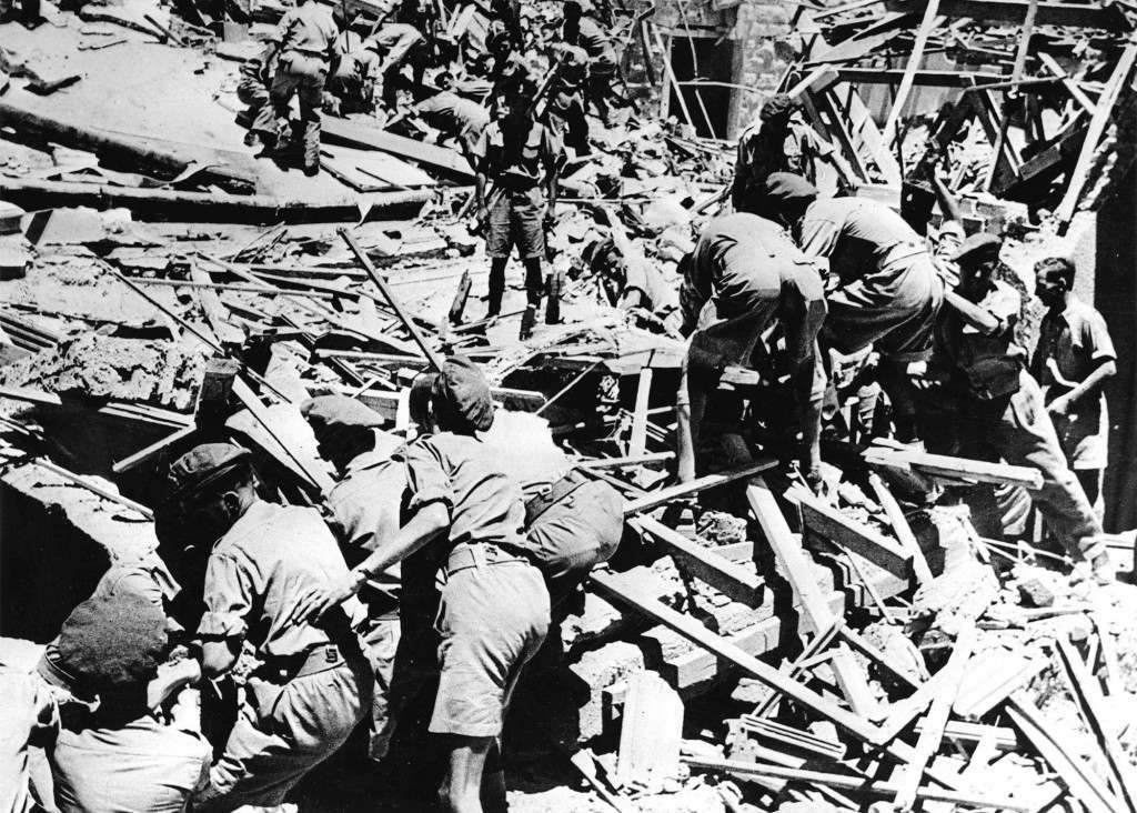 Many lives were lost an dozens of persons were injured when terrorists blew up part of the King David hotel, Jerusalem, which houses the Palestine Government secretariat and the H.Q. of the Palestine Army command. Our Associated press photo shows soldiers digging through rubble of the King David hotel after the explosion on July 22, 1946, to remove dead and injured. Ref #: PA.2508892  Date: 22/07/1946