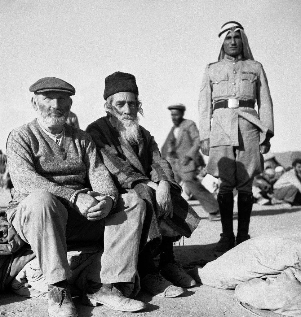 Legion guards with two orthodox Jews who preferred imprisonment in Trans-Jordan to going into Jewish-held area of Jerusalem, which is also still a battle zone on June 4, 1948 in Trans-Jordan. (AP Photo/Daniel De Luce ) Ref #: PA.7091318  Date: 04/06/1948 