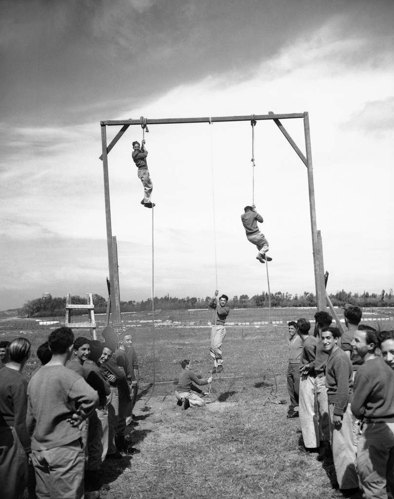 With registration on full swing, Haganah, the Jewish defense organization, puts all recruits through stiff training courses on March 11, 1948 in Jerusalem. There are several such camps, set up in secret locations. Besides training in the sued of arms, the youths are pout through a strenuous body conditioning program. At one stage of training, the recruits climb hand-over-hand up hanging ropes. (AP Photo) Ref #: PA.7445873  Date: 11/03/1948 