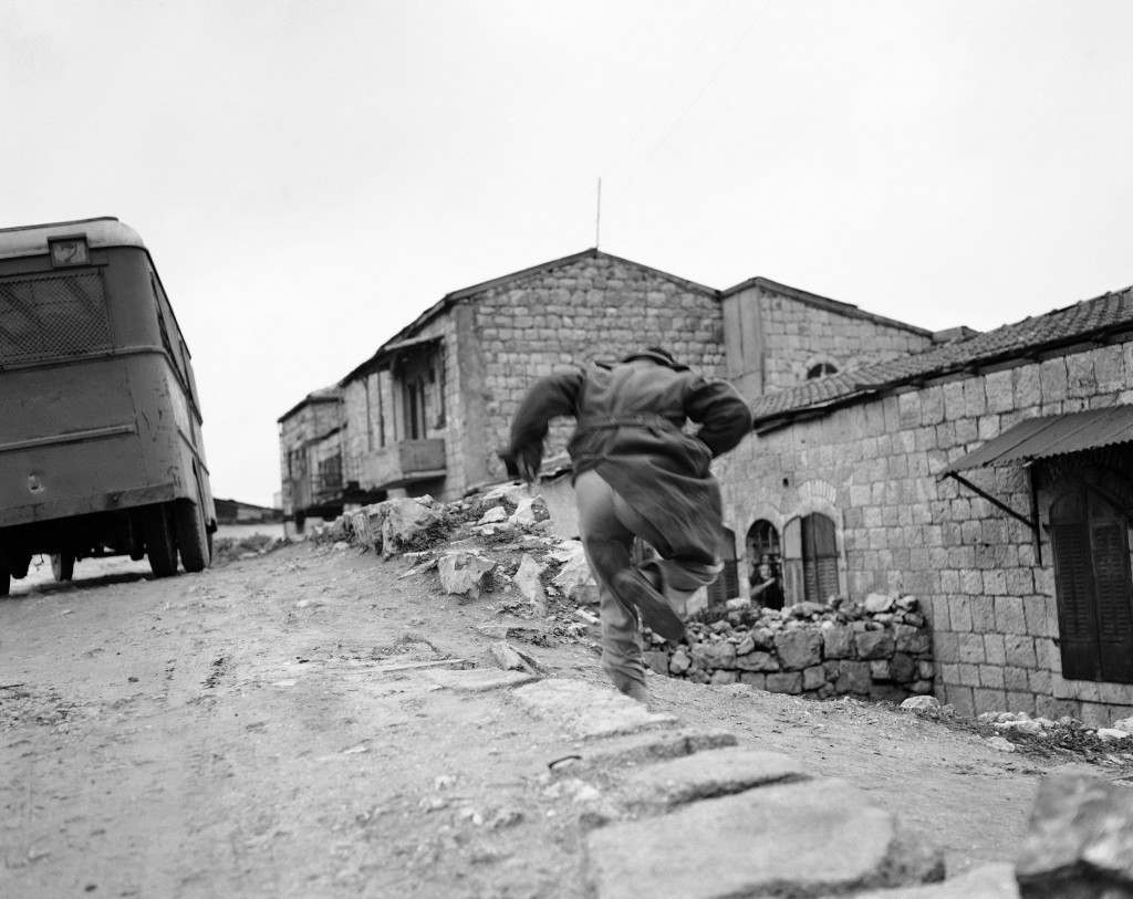 Caught in the open during Arab-Jewish skirmish in Montefiore, a Jewish quarter in Jerusalem, Palestine, a Jew dashes for cover as an Arab sniper fires on him, Feb. 10, 1948. Two British companies were called out to halt the battle which started when Arabs attempted to smash into Jewish quarter of the city. (AP Photo/Jim Pringle) Ref #: PA.7450598  Date: 10/02/1948