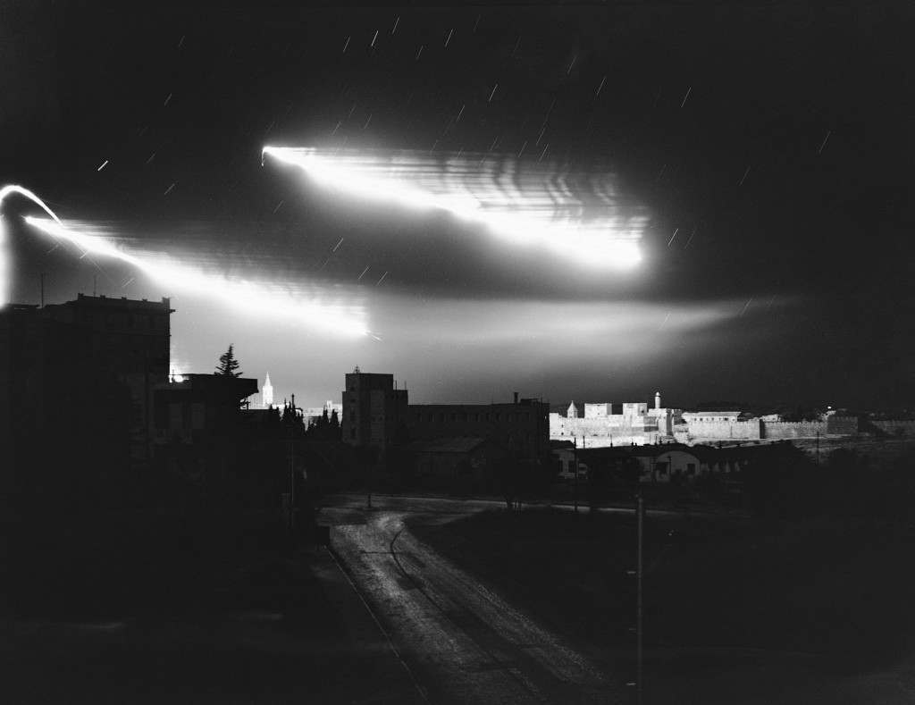 The glare from fires set by mortar and artillery shells and the flares set up by opposing fighters in the fierce battle between Arabs and Jews light up the sky above the David's Tower section of the Old City Wall of Jerusalem, held by the Arabs, July 14, 1948. It was one of the heaviest exchanges of fire in the long struggle for the Holy City. (AP Photo/Jim Pringle) Ref #: PA.7450612  Date: 14/07/1948