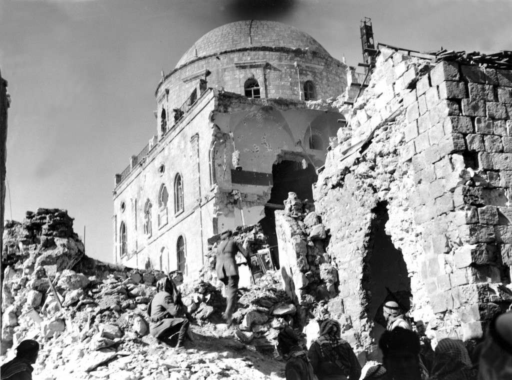Arab soldiers approach a huge breach in the walls of Tiferet Synagogue, a stronghold of the Haganah in the Old City of Jerusalem, on May 21, 1948 during the Arab-Israeli War. Arab demolition squads blasted holes in the structure which was being used as a fortress by Haganah forces, an underground Zionist military organization. (AP Photo) Ref #: PA.8665222  Date: 21/05/1948 