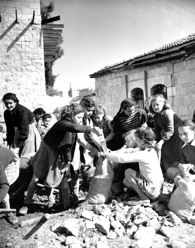 Sandbags for defense works are filled by Jewish girls in the Montefiore quarter of Jerusalem in Feb. 1948. The girls belong to the few Jewish families still remaining in the section with members of the Haganah, Defense Organization. This section has been under constant attack by Arab snipers from the Old City during Arab-Jewish conflict after United Nations decision to partition Palestine. (AP Photo/James Pringle) Ref #: PA.8666931  Date: 01/02/1948