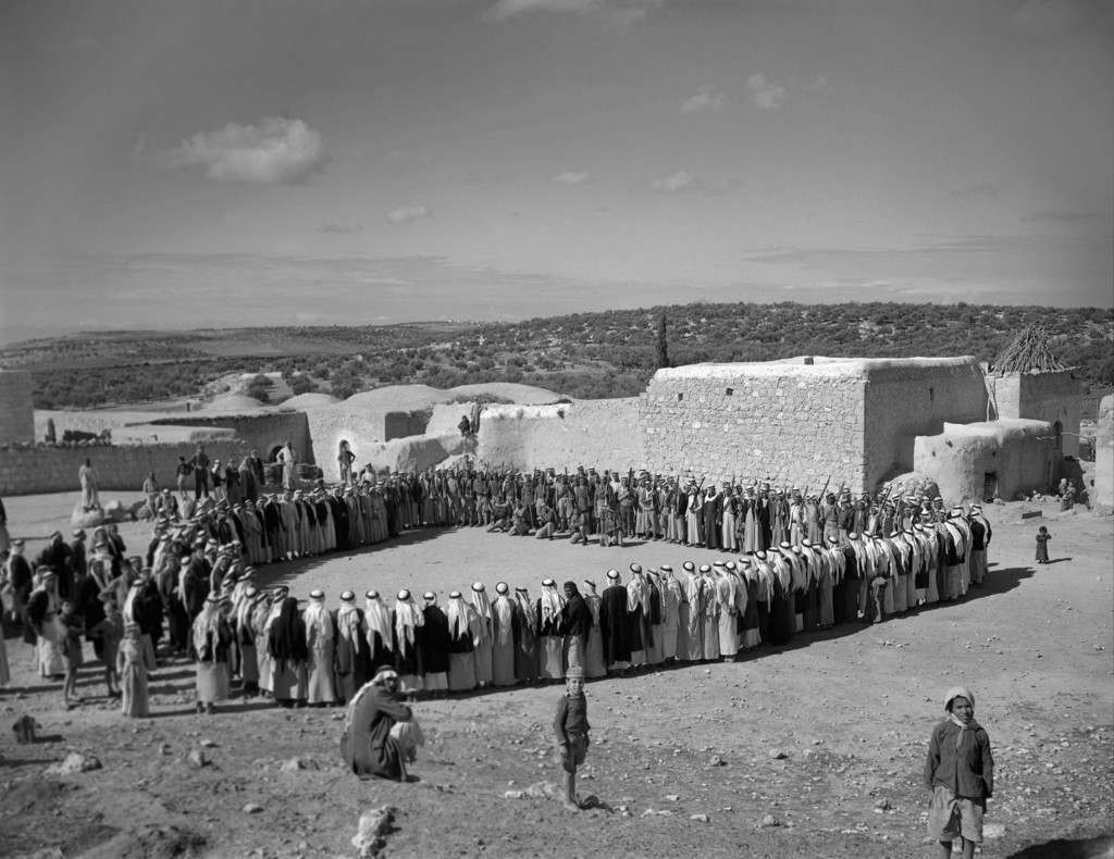 The scene at Arab hillside village on a Muslim Sabbath in Palestine, Jerusalem, Friday, March 31, 1948, when two families who had split the village into rival camps with a blood feud for the past two years set aside their differences, so that they might wage war against the Jews instead of each other. TheyÂ’re shown forming a rough circle with members of one family on the left, members of the other on the right, and Arab soldier volunteers in center background. Afterwards the male members of the two family factions advanced toward one another and shook hands. The feud, which began with the killing of a member of one family, was the first in Palestine thus formally set aside. The truce was solemnized by a feast. (AP Photo) Ref #: PA.8996275  Date: 31/03/1948