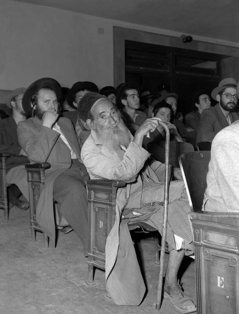 An unidentified Orthodox Jew, wrinkled with age, wearing a long beard, tattered robes and cane, attends a session of the United Nations Special Committee on Palestine in Jerusalem, June 16, 1947, to hear Joseph Zvi Dushinski, Chief Rabbi of Agudath Israel Congregation in Palestine, speak on behalf of his group. (AP Photo/James Pringle) Ref #: PA.8996280  Date: 16/07/1947 