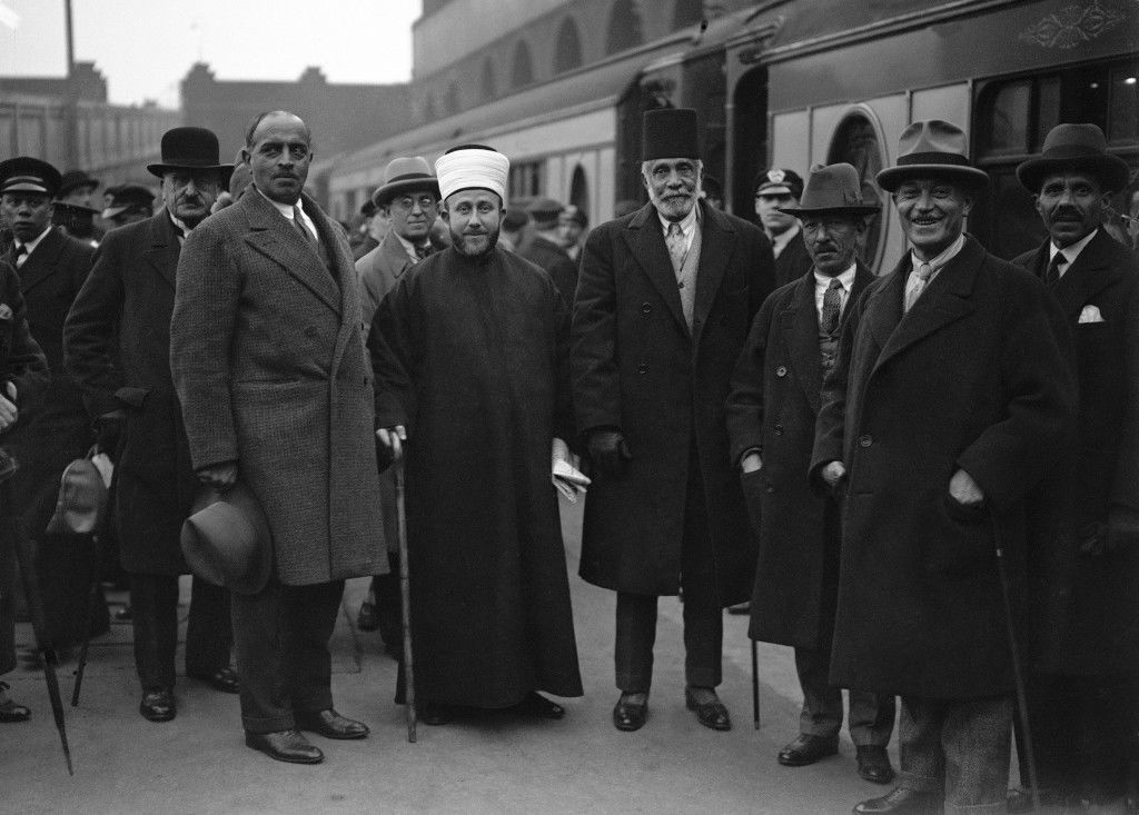 The Grand Mufti of Jerusalem, white head wear and Musa Kazim Pasha El Husseini, center right, aged 82 photographed on arrival at Victoria Station in London on March 30, 1930. The delegation is in Britain to urge, among other things, the establishment of a Palestinian National Democratic Government in which both Arabs and Jews will participate in proportion to their numbers. The delegation is headed by Musa Kazim Pasha El Husseini in accordance with Arab custom of giving the precedence to age. (AP Photo) Ref #: PA.9431308  Date: 30/03/1930