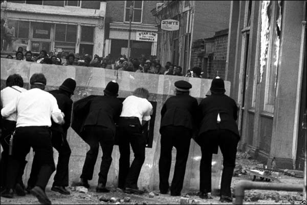 Police confront a group of youths from behind their riot shields in Mayall Road, Brixton, during renewed fighting between police and black youths.