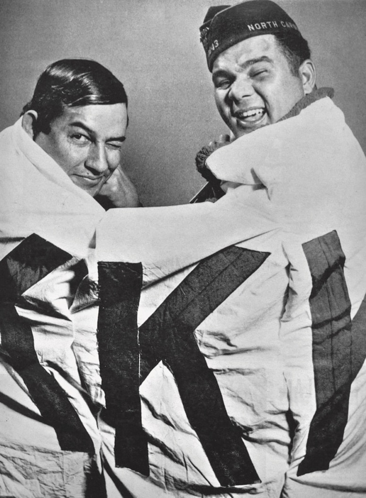 Charlie Warriax (left) and Simeon Oxendine (right) bear a captured KKK banner. Courtesy of the Charlotte Observer Photograph Collection, Public Library of Charlotte and Mecklenburg County.