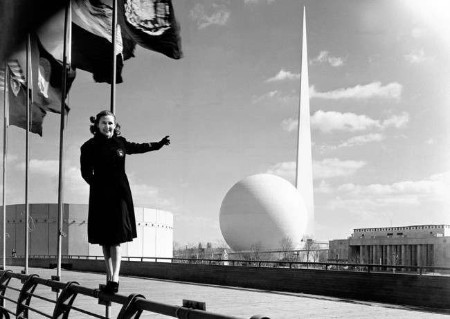 Rosalie Fairbanks, a guide to the New York World's Fair, points to the theme of the exposition -- the Trylon and Perisphere -- in New York on February 22, 1939, after the entire sheath of scaffolding was removed for the first time. 