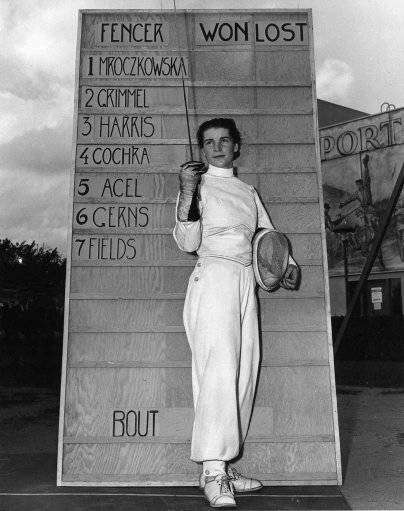 National women's champion Helena Mroczkowska, 22, of Hicksville, N.Y., poses in front of the leader board at the start of a fencing championship at the World's Fair in New York in Sept. 15, 1940. Mroczkowska Dow, a four-time national fencing champion and a former U.S. Olympic member, has died of cancer Wednesday, Arpil 22, 1998. She was 80. Dow, part of a famous Olympic family, won the first of her four Amateur Fencers League of America national foil championships in 1940. She also won the title in 1943, 1947 and 1948. 