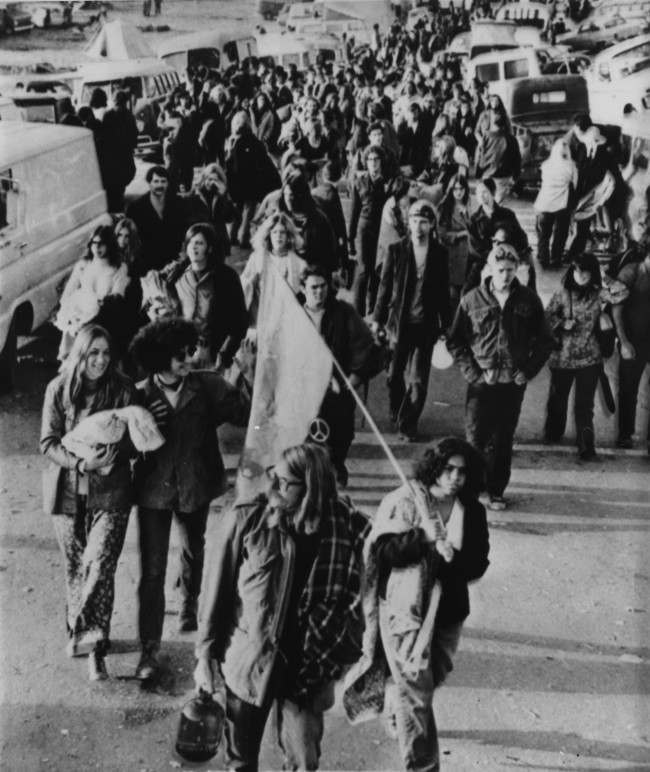 Rock fans abandon their cars as they march along the road to the site of a free rock concert at the Altamont Speedway, near Livermore, California, featuring The Rolling Stones, December 6, 1969.