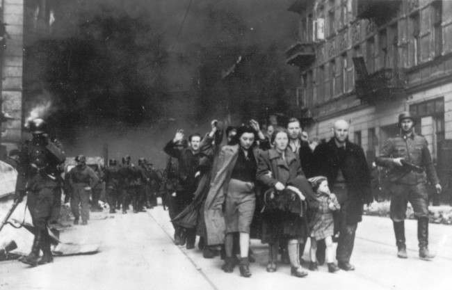 FILE - In this 1943 file photo, a group of Polish Jews are led away for deportation by German SS soldiers during the destruction of the Warsaw Ghetto by German troops after an uprising in the Jewish quarter. Sixty years after a landmark accord started German government compensation for victims of Nazi crimes, fund administrators and German officials say payments to Holocaust survivors are needed more than ever as they enter their final years. German Finance Minister Wolfgang Schaeuble is to sign off officially Thursday Nov. 15 2012 on revisions to the original 1952 compensation treaty, increasing pensions for those living in eastern Europe and broadening who is eligible for payments. (AP Photo, file)