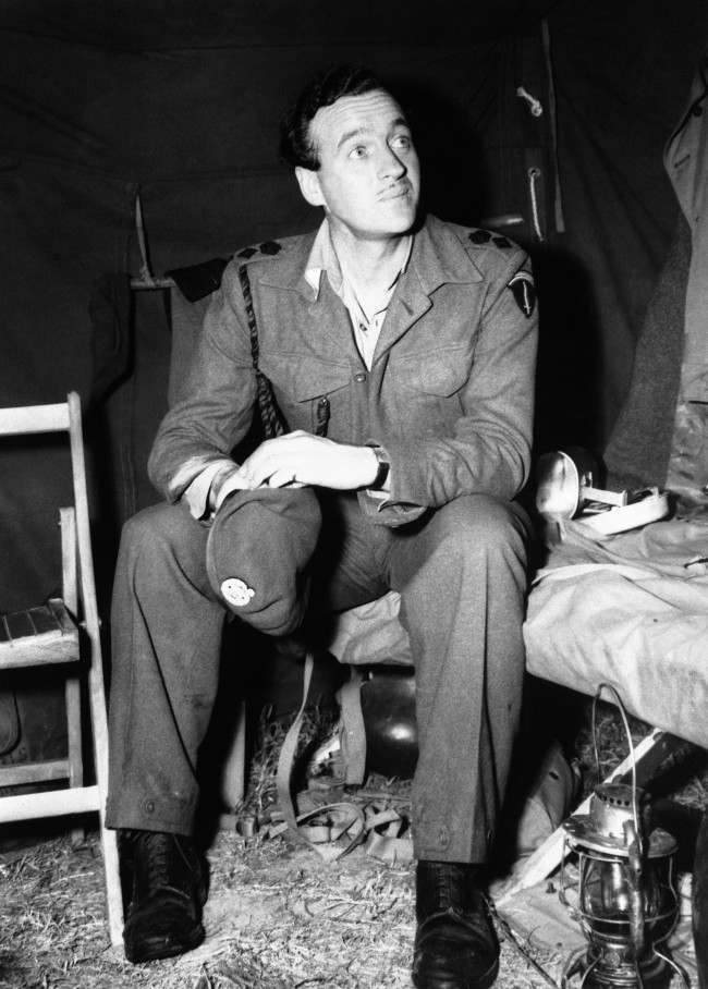 Lieutenant Colonel David Niven, British film star, now with SHAEF, seen in his tent somewhere in Normandy, France on July 5, 1944. (AP Photo)