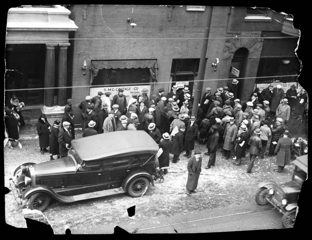 A crowd outside the Clark Street garage, owned by George “Bugs” Moran ...