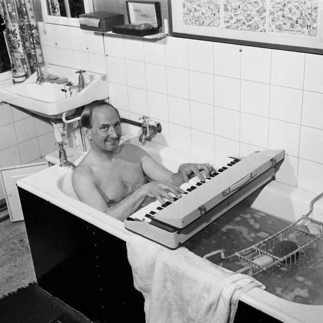 Concert pianist, Joseph Cooper, who is to play at this years Bath Festival is in constant rehearsal. He is pictured using a dummy key board even while taking a bath at his home in Surrey. Picture date: 11th May 1964. former BBC "Face The Music" presenter, Mr Joseph Cooper. The 88-year-old pianist and broadcaster died yesterday morning August 5 2001 at the Nuffield Hospital in Guildford, Surrey, after a short illness, a friend said. He is pictured at his home in Surrey before performing at Bath Festival.