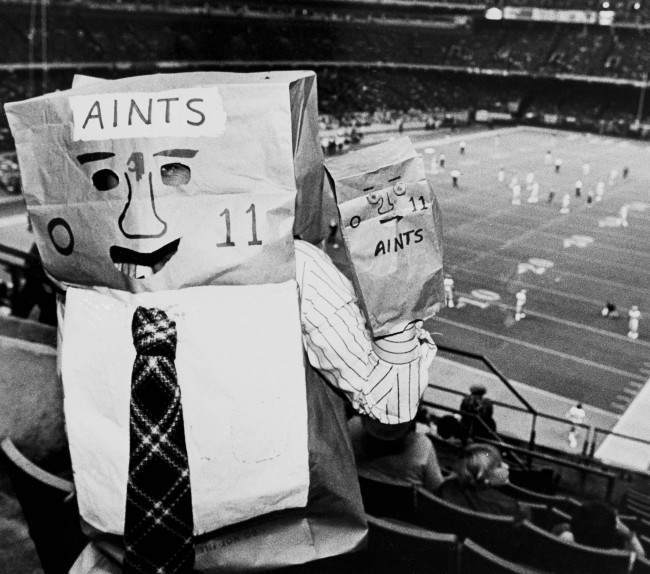 A New Orleans Saints fan wears a bag over his head pointing out the teams 0-11 record this season during game with the Los Angeles Rams in the Superdome in New Orleans, Nov. 24, 1980. 