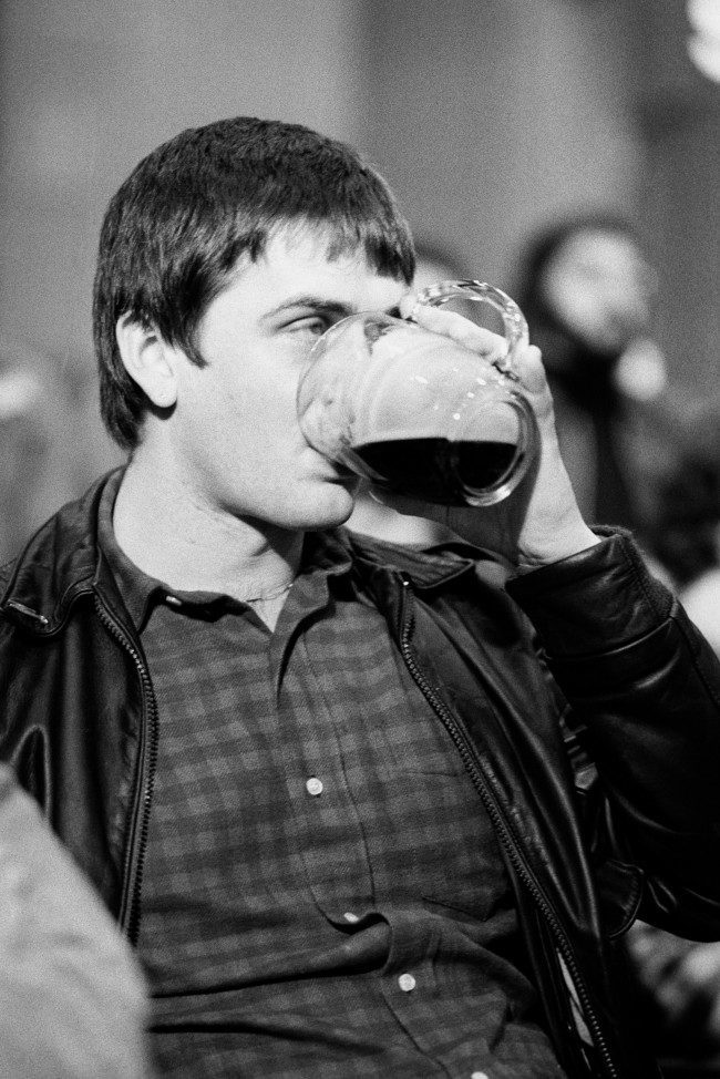 Pop star Mike Oldfield drinking a pint of beer whilst at Abbey Road Studios where there was an auction to sell off the Beatles belongings