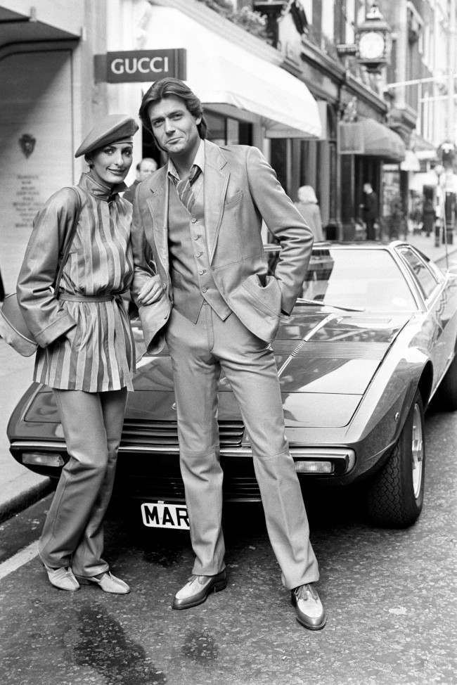 ucci Autumn and Winter Collection - 1980 Oliver, right, wearing a Nappa leather and velour suit. Christa, left, in a suit of similar fabrics.