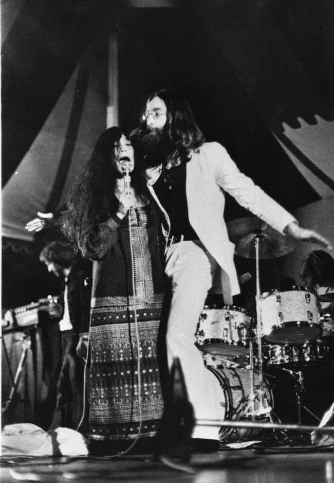 John Lennon and his wife Yoko Ono perform in their first public appearance as the Plastic Ono Band, at Toronto's Varsity Stadium, Sept. 14, 1969. 