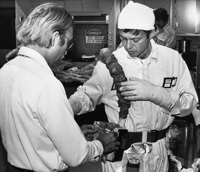 George Kalman, right, a U.S. Nuclear Regulatory Commission engineer, has part of his breathing apparatus checked by a Three Mile Island PWR technician, on November 13, 1980, in Middletown, Pa., as he prepares to enter the containment building housing the damaged No. 2 nuclear reactor. This is the fourth manned entry into the building since March 28, 1979, when the reactor core was severely damaged in an accident, and radiocativity was released into the atmosphere.