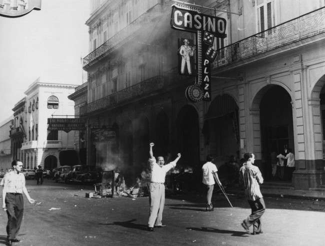 People burn tables and roulette wheels outside the Plaza Hotel casino in Old Havana, Cuba in Jan. 1959 