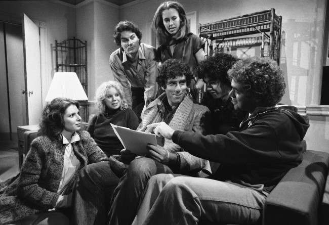 Elliot Gould holds the script as he rehearses with the new cast of "Saturday Night Live" in New York, Nov. 13, 1980. They will make their debut with guest host Gould on November 15. From left: Ann Risley, Denny Dillon, Charles Rocket, Gail Matthius, Gilbert Gottfried and Joe Piscopo. 