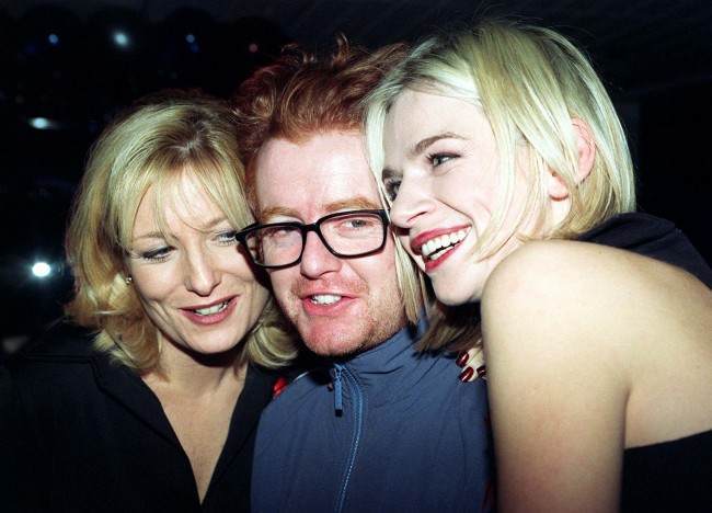 Library filer dated 1/12/96 of winner Chris Evans (Top C4/BBC2 Entertainment Presenter) being hugged by award presenters Gaby Roslin (left) and Zoe Ball at the British Comedy Awards 1996 at the London Television Centre. It was announced today (Thur), that Evans is to leave Radio One on March 27, the BBC said. Evans wanted to have every Friday off from presenting his Breakfast Show but BBC Radio 1 controller Matthew Bannister refused. Mr Bannister told Evans it did not fit in with his plans for the station's schedule.