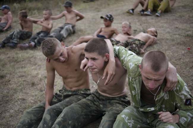 Participants in a youth military camp have training at the camp, some 60 km (38 miles) of Simferopol in the Ukrainian Black Sea Crimean Peninsula, Saturday, Aug. 4, 2012. This summer some 100 boys aged 8-18 from across Russia and Ukraine took part in a youth military camp in Crimea, learning to climb mountains, survive in the woods, shoot various rifles, navigate unknown terrains and conduct reconnaissance trips, all in their name of defending their motherland. The "military patriotic" camp is organized by the Union of CrimeanÂs Cossacks, an ethnic Slavic warrior cast that for centuries defended Russia's borderlands against invasion and served as the spearhead of Russia's imperial armies. 