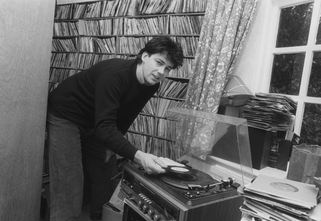 Radio One DJ Mike Read, 36, plays one of his favourite records at his Victorian-Gothic seven-bedroom Surrey mansion near Dorking. Read, who has spent three years setting 20 poems by the late Poet Laureate Sir John Betjeman to music, hopes to stage a musical entitled "Teddy Bear to the Nation" with the backing of composer Andrew Lloyd Webber in London's West End this summer. Date: 12/03/1987