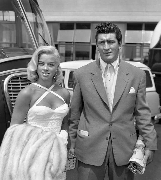 Film star Diana Dors, who has filed a divorce petition against her husband, Dennis Hamilton, pictured with actor Tommy Yeardye before they left London Airport for Rome. Ref #: PA.1945649 Date: 02/07/1957