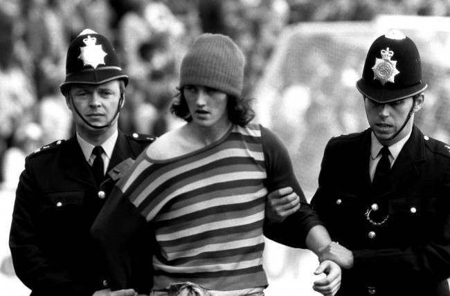 Soccer - Football League Division Two - Orient v Manchester United A Manchester United fan is arrested by two policemen NULL Ref #: PA.398282 Date: 17/08/1974