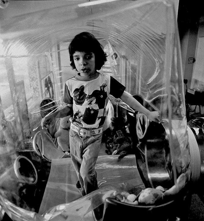 David Vetter poses inside of his bubble in his Houston home in this Dec. 17, 1976 file photo. Vetter was born with a genetic disorder leaving him no natural immunities against disease. The disorder, known as Severe Combined Immune Deficiency Syndrome (SCID), became known as "Bubble boy Disease", so named because of Vetter. (AP Photo/File)