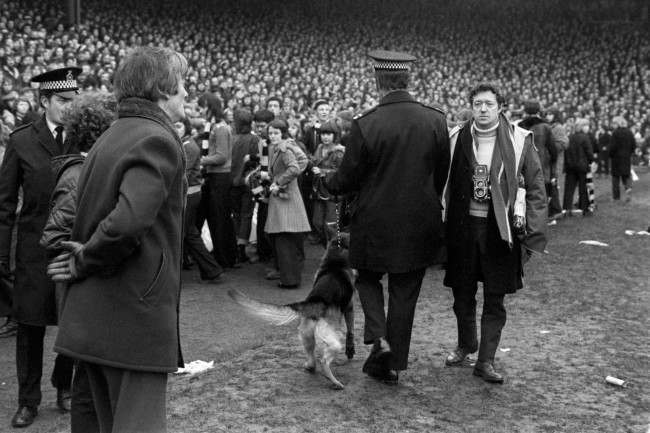 PA. 723459 Soccer - FA Cup - Sixth Round - Newcastle United v Nottingham Forest A policeman with an Alsatian herds the Newcastle United fans back onto the terraces after they invaded the pitch, hoping to get the match abandoned with their team 3-1 down and a man short Ref #: PA.723459 Date: 09/03/1974 