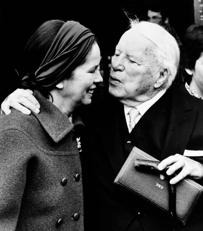 Actor Charlie Chaplin kisses his wife Oona outside of Buckingham Palace in London, March 4, 1975, after being knighted by Queen Elizabeth II in a private ceremony. In his hand is the box containing the insignia of Knight Commander of the Most Excellent Order of the British Empire.