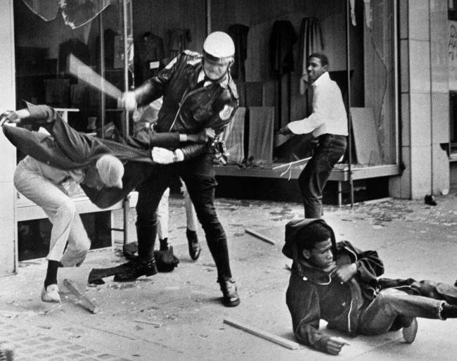 A police officer uses his nightstick on a youth reportedly involved in the looting that followed the breakup of a march led by Dr. Martin Luther King Jr. March 28, 1968, in Memphis, Tenn. Black leaders accused the police of brutality while police officers said they did what was necessary to restore order. In the wake of the violence, a curfew was imposed and more than 3,800 National Guardsmen were rushed to the city. A week later, King was assassinated at Memphis' Lorraine Motel. (AP Photo/Jack Thornell)