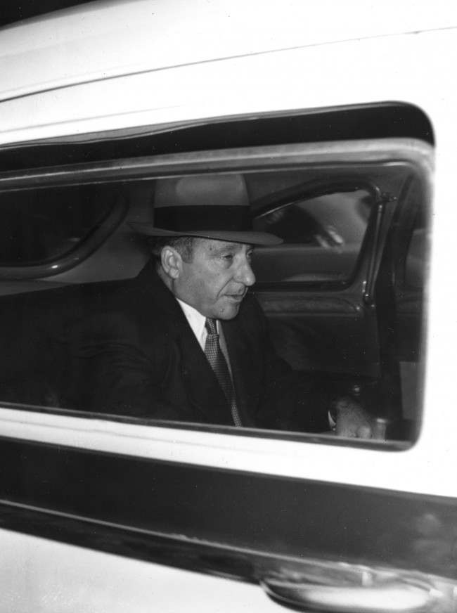 Gambler Frank Costello, who stormed out of the Senate Crime Investigating Committee hearing on March 15, sits back in a taxicab as he leaves his home to return to Federal Court in New York City, March 16, 1951, for further questioning. Costello had been told he would be arrested and brought before the committee forcibly if he did not apear at 2pm March 16. 