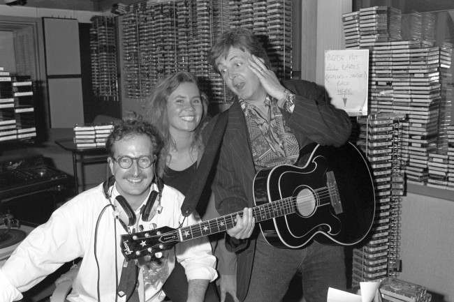 Paul McCartney surprising Radio 1 DJ Steve Wright and his production assistant Dianne Oxberry by dropping in for a chat after they broadcast an on-air appeal to meet him. Diane mentioned McCartney's name during a talk about the stars people would love to meet, and as he was working down the road on his new album, McCartney strolled into the studio and played live for Diane. Ref #: PA.8792508 Date: 13/06/1990 