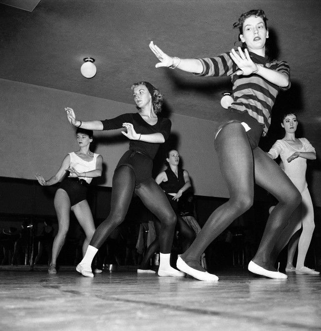 Thirty-six girls, dancing as one on the huge stage of New YorkÂs Radio City Music Hall on Oct. 15, 1958, are the envy of many other girls throughout the United States. The dancers are the celebrated Rockettes. One of the dancers, Mary Ann Strilka of Olyphant, Pa., in a black leotard, white ballet slippers and socks is caught by the camera in some of the behind-the-scenes work at the theater. 