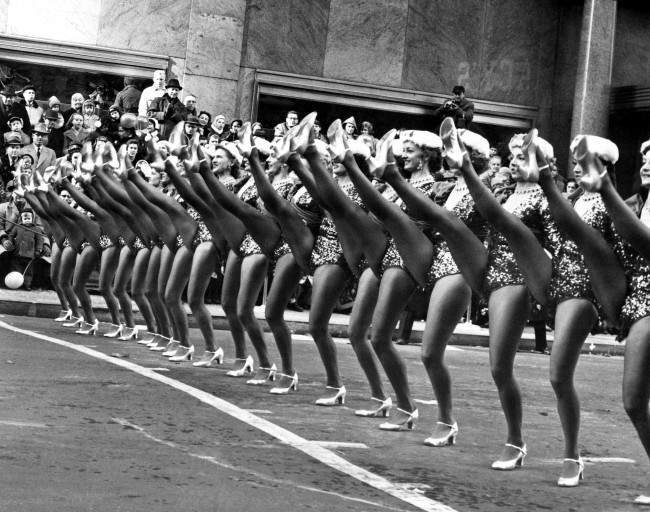 Some of the Radio City Music HallÂs Rockettes as they were performing in the annual MacyÂs Thanksgiving Day parade in New York on Nov. 27, 1958. Some of the police-estimated 1,250,000 that watched the parade keep an eye on the dancers as they approach 34th Street and Broadway, near the end of the march. 