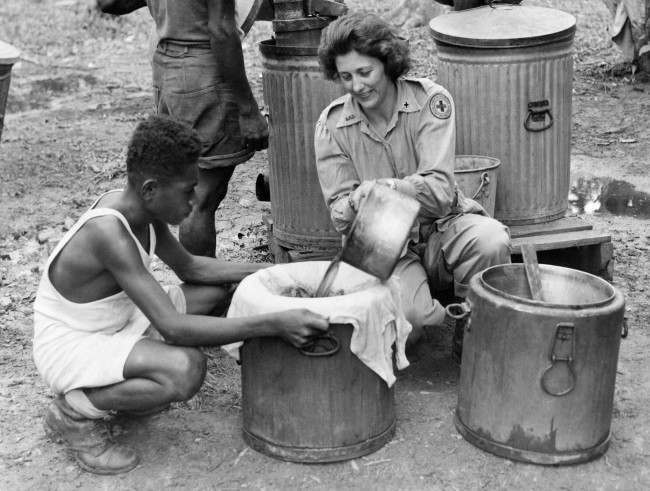 Red Cross worker Marie Salcheider, of St. Paul, Minn., fills vats with freshly made coffee, at a base in Dutch New Guinea on Oct. 23, 1944. The coffee will be transported in mobile canteens to isolated areas. 