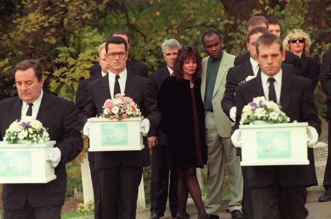 Mandy Allwood with her partner Paul Hudson with the coffins of the eight unborn babies of Mandy Allwood are carried in procession during their funeral in West Norwood Cemetery, London. Max Clifford her publicist stands behind her Ref #: PA.1064797  Date: 14/10/1996