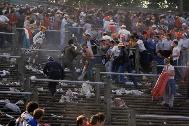 European Cup - Final - Liverpool v Juventus - Heysel Stadium Chaos erupts on the terraces as a single policeman tries to prevent Liverpool and Juventus fans getting stuck into each other Date: 29/05/1985