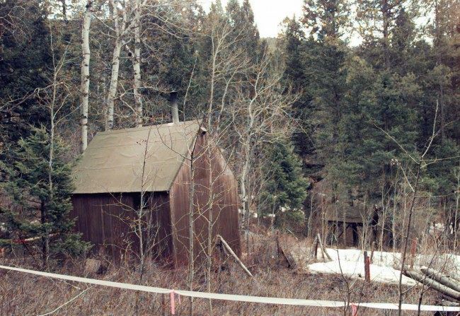 The cabin of suspected Unabomber Theodore Kaczynski, partially surrounded by white, plastic tape, sits at the end of a muddy, private road, hidden in a wooded setting about 300 yards from the nearest neighbor Saturday, April 6, 1996 in Lincoln, Mont. The home, on 1.4 acres, is only 10 by 12 feet, with no electricity or plumbing. (AP Photo/Elaine Thompson) Date: 06/04/1996
