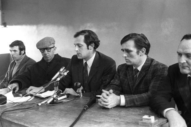 Joe Cahill (centre) school gym Ballymurphy northern ireland speaking talking, chief of the Provisionals in Belfast, who during today's Press conference refuted claims made by the army a few hours earlier that the IRA were virtually beaten. He said the Provisionals and the Regular IRA were now joining forces to fight the Army. His Press conference ended abruptly when guards posted on nearby street corners warned of approaching British Army patrols. Date: 13/08/1971